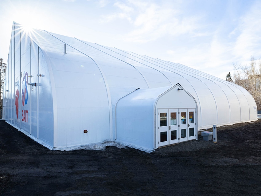 White fabric building with large graphics on the Sprung structure gymnasium